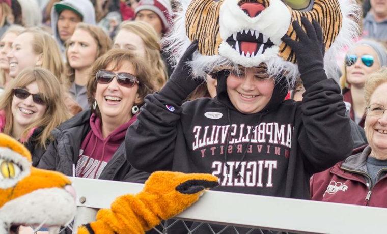 Kelsey Peavler smiles as Clawz the mascot greets her at the 2017 Homecoming Football Game